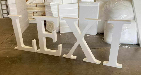 four large white letters spelling LEXI creating a decorative display ideal for celebrations or events related to the number 10